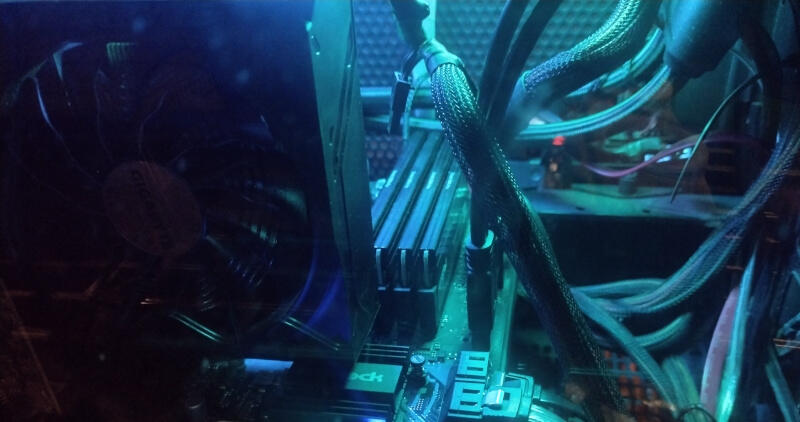 A view of the inside of a computer lit up in green and blue