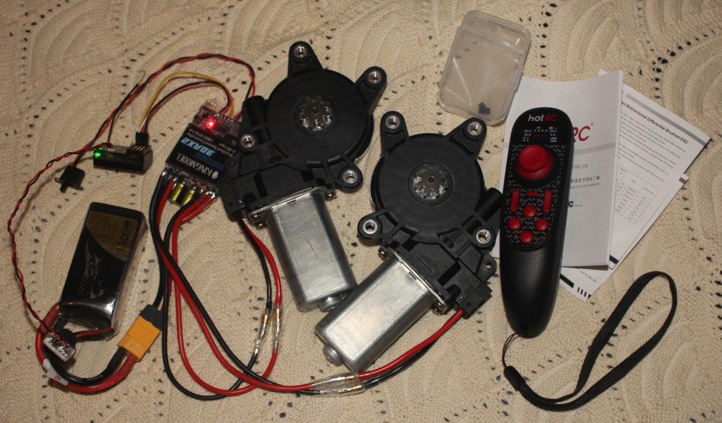 Photograph of some R/C components attached to a pair of automotive window motors